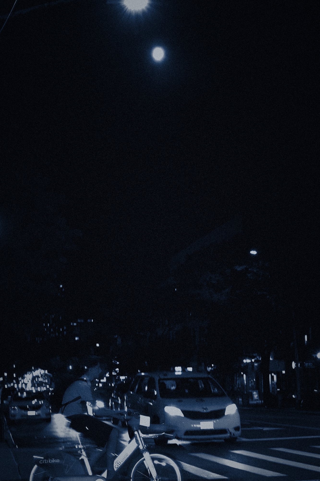 3:49 AM. The moon, a cab, a bicycle. Nobody on the bicycle.